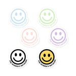 Blue, green, pink, purple, black, and yellow smiley face The Women's Network stickers.